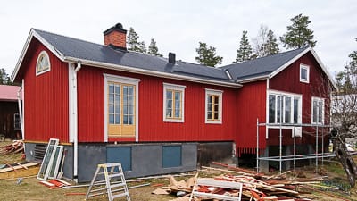 Hus med många fönster där glasrutorna ger tydligt ljusinsläpp och markerar fönsterplaceringen i fasaden.